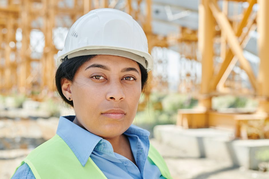 Portrait of a female engineer wearing a hard hat and safety vest on a construction site